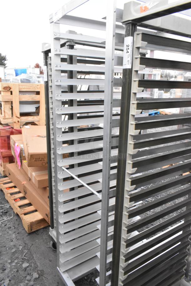 Metal commercial pan transport rack on casters, used condition. Multiple slotted shelves, sturdy frame, ideal for kitchen use.