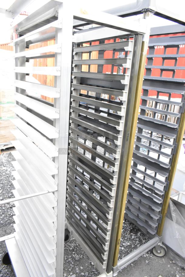 Metal commercial pan transport rack with multiple trays on durable commercial casters, excellent condition.