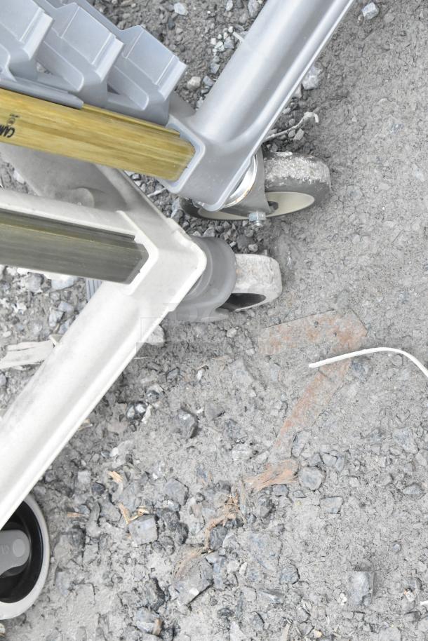 Metal commercial pan transport rack on sturdy casters, featuring durable construction for industrial use.