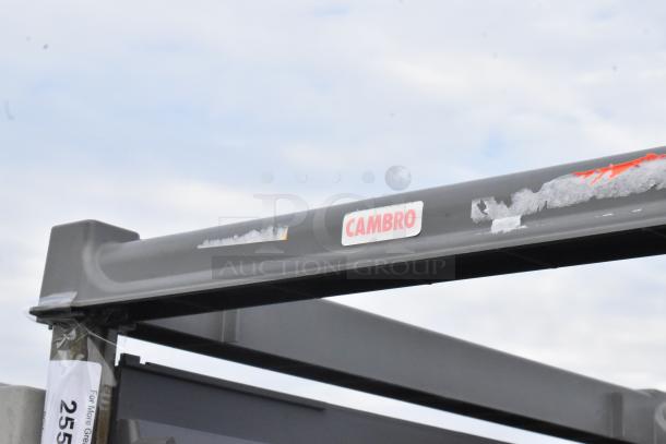 Metal commercial pan transport rack with Cambro label, on commercial casters, in good condition.