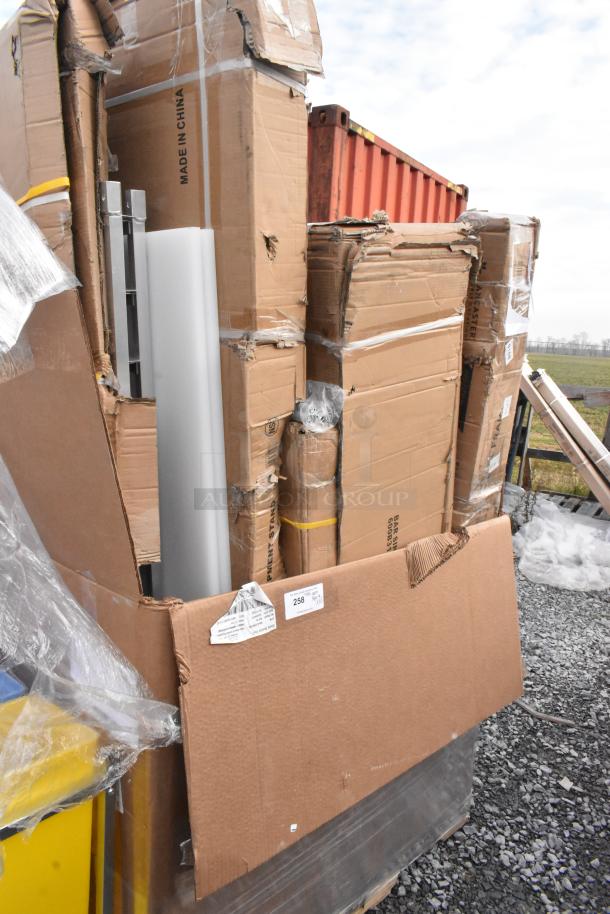 Stack of brand new scratch and dent items in damaged boxes; includes shelf, work table. "Made in China" label visible.