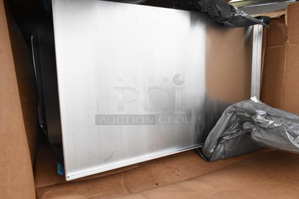 Brand new stainless steel cart with scratch and dent marks, visible in packaging. Auction offers two units per bid.