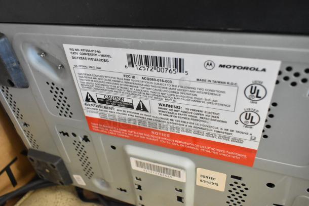 Motorola CATV converter model DCT2244/1661 with caution and warning labels visible. Signs of wear.