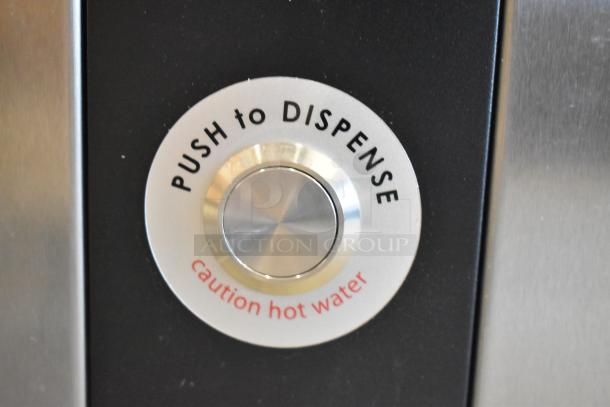 Close-up of a Grindmaster 1000666GM PB10US ecoboiler button. The label reads "Push to Dispense, caution hot water."