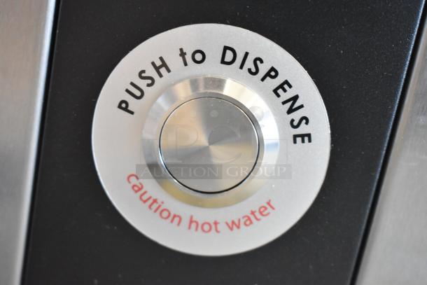 Button on Grindmaster 1000666GM Ecoboiler, labeled "Push to Dispense" and "Caution Hot Water," stainless steel finish.