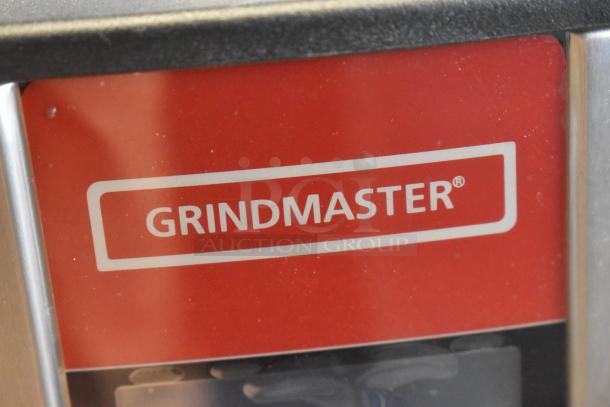 Grindmaster logo on red background, part of BRAND NEW SCRATCH AND DENT Ecoboiler hot water dispenser, model 1000678GM.