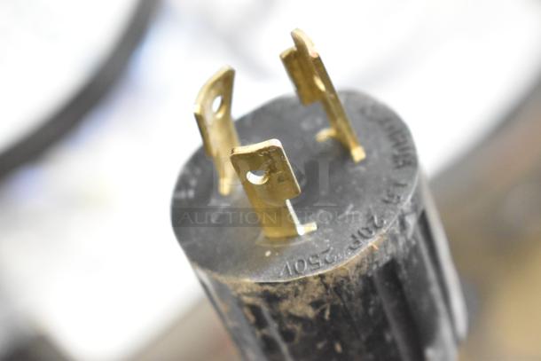 Close-up of a power plug for Grindmaster 1000678GM hot water dispenser. Marked "240V". Plug shows light wear.