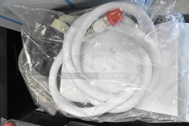 Plastic-wrapped accessory kit for Grindmaster 1000665GM Ecoboiler. Includes white tubing and red-capped connector. Brand new.