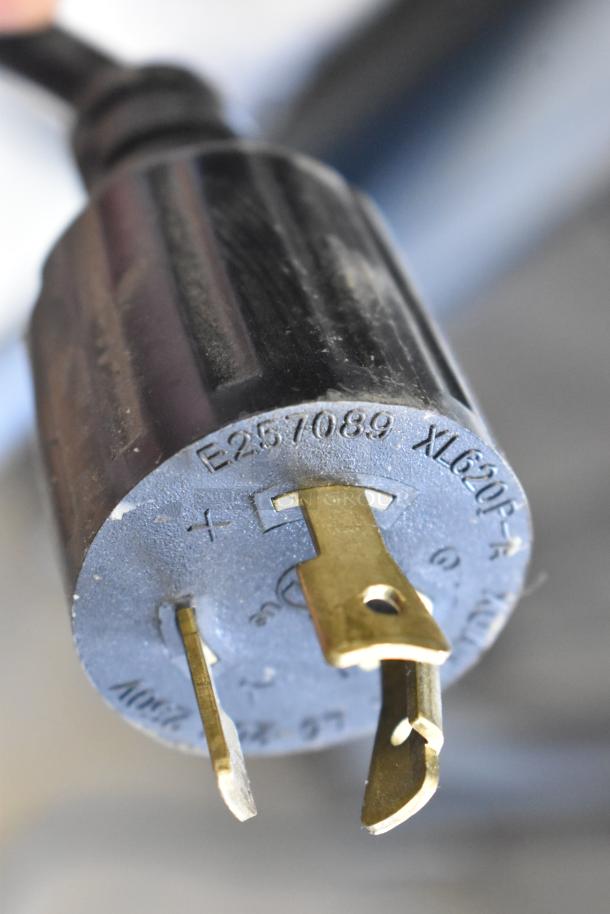 Close-up of a plug for the Grindmaster 1000665GM PB5US Ecoboiler, showing prongs and labeling "E257089 XL620-F".