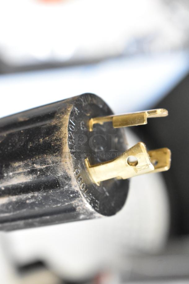 Close-up of a power plug for the Grindmaster 1000665GM PB5US Ecoboiler. Plug shows some surface wear.