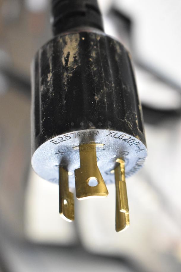 Power plug of a Grindmaster 1000665GM Ecoboiler, stainless steel, 240V, 1 phase, scratch and dent condition, model markings visible.