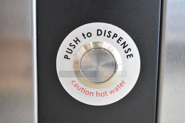 Grindmaster Ecoboiler push button, text reads "Push to Dispense" and "Caution Hot Water," stainless finish visible.