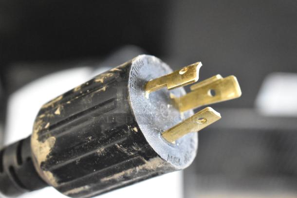 Close-up of a power plug for the Grindmaster 1000666GM PB10US Ecoboiler, showing slight scratches.