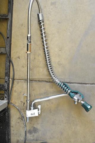 Metal faucet with spray nozzle, chrome finish, flexible hose, spring support. Auction tag: 270. Excellent condition.