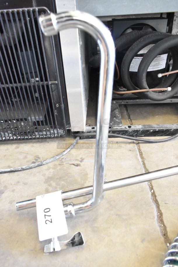 Metal faucet with spray nozzle, chrome finish, includes installation instructions. Auction tag numbered 270.