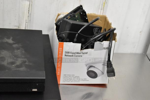 Security camera kit with 8 cameras, including 2 Dahua units, in original box. Box features EXIR Fixed Mini Turret Network Camera details.