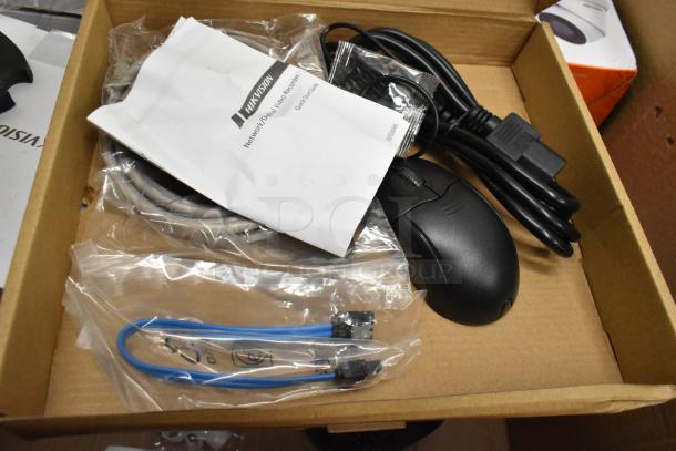 Security camera kit including 8 cameras, 2 Alhua units, cables, mouse, and Hikvision user manual in box.