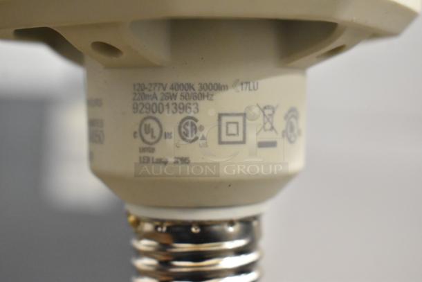 Close-up of a LED bulb base with label showing model 9290013963, 120-277V, 4000K, 3000lm, UL and CSA safety marks.