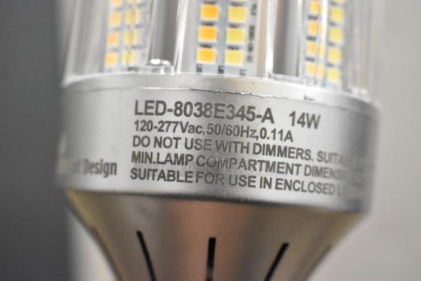 Close-up of LED lightbulb, model LED-8038E345-A, 14W, 120-277V, with safety and usage specifications. 44 bulbs available.