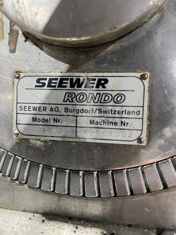 Seewer Rondo SS063 dough sheeter, model tag visible, SN: A-3088002. Commercial electric, reversible conveyor belt.