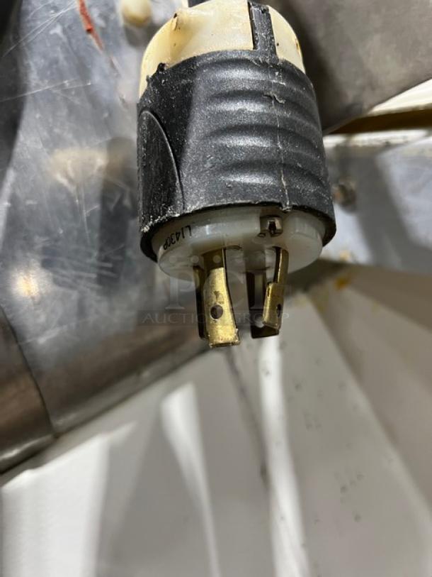 Seewer Rondo SS063 electric dough roller/sheeter plug, close-up, showing gold prongs and black casing. Model SS063 SN: A-3088002.