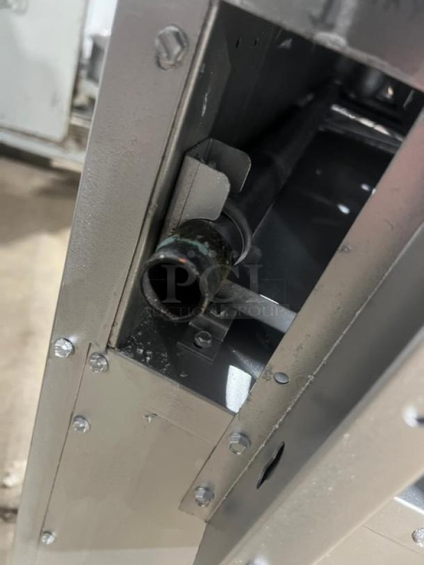 CPG S60-N gas range, 10 burners. Features stainless steel build, backsplash, salamander shelf, and oven rack on casters.