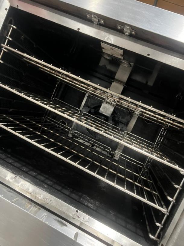 Vulcan SG4D1 double-stacked stainless steel convection oven, natural gas powered, with wired oven rack, on casters.