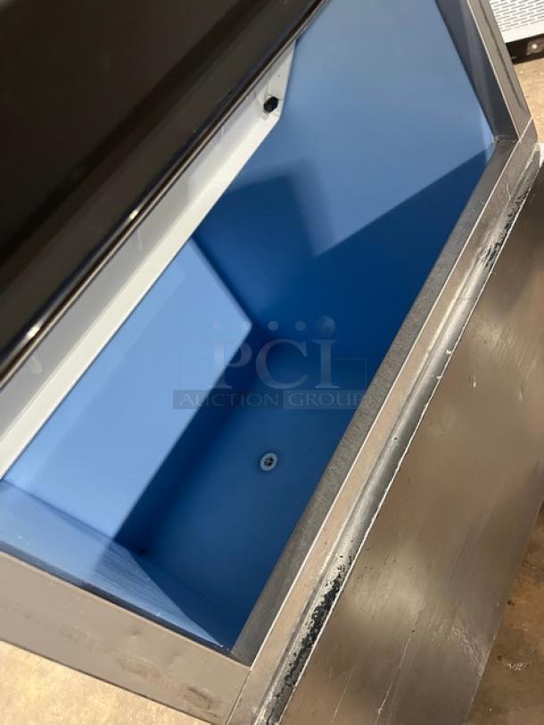 Hoshizaki KM-1340MRJ/B-500PF stainless steel ice maker bin, electric powered, modular crescent cube style, on legs.