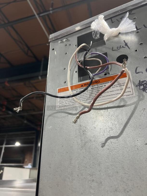 Hoshizaki stainless steel ice machine wiring exposed, model KM1340MRJ/B-500PF, with warning label, on legs, 208-230V.