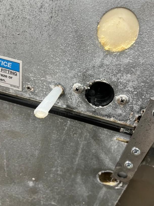 Hoshizaki KM1340MRJ/B-500PF ice maker with visible piping and fittings, showing stainless steel exterior.