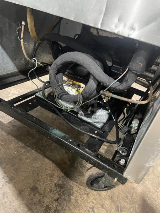 True T-23F commercial stainless steel single door reach-in freezer on casters, showing motor components. Energy Star certified.