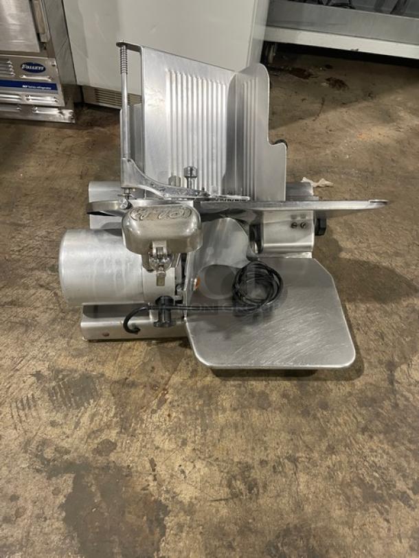 Globe 500L heavy-duty electric meat slicer, stainless steel, countertop model, on legs; power cord included; used condition.