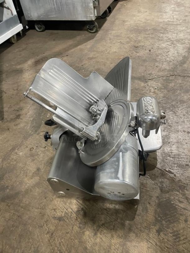 Globe 500L stainless steel electric meat slicer on legs, heavy-duty, commercial-grade, countertop model, in good condition.