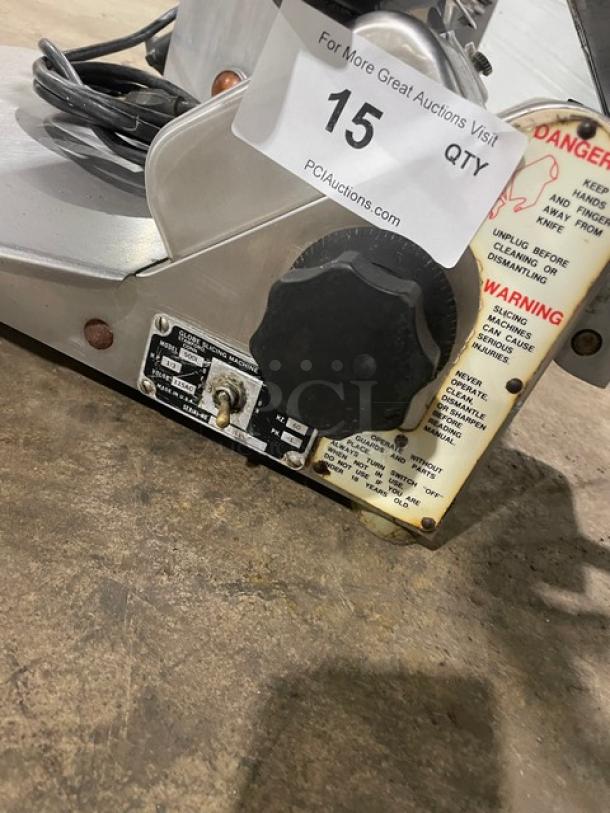Globe 500L stainless steel electric meat slicer with controls visible, on legs. Used, heavy-duty, countertop model.