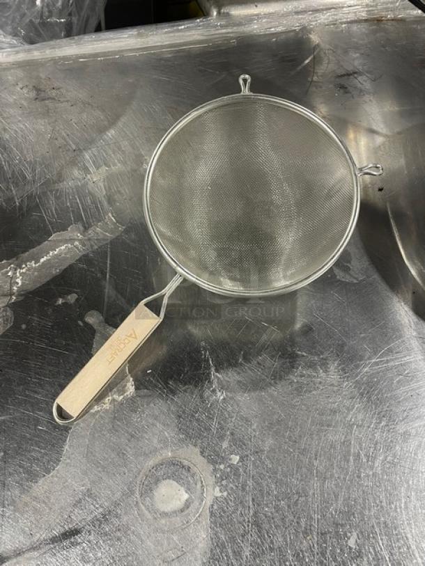 Adcraft stainless steel heavy-duty strainer with hardwood handle, excellent condition, featuring fine mesh for efficient straining.