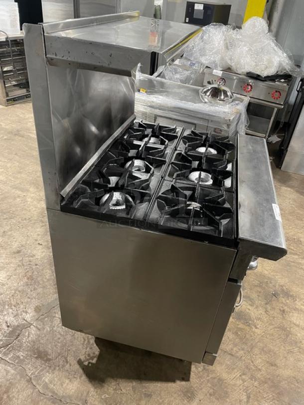 American Range 6-burner stainless steel gas range/oven combo with backsplash, overhead shelf, and wired rack. Excellent condition.