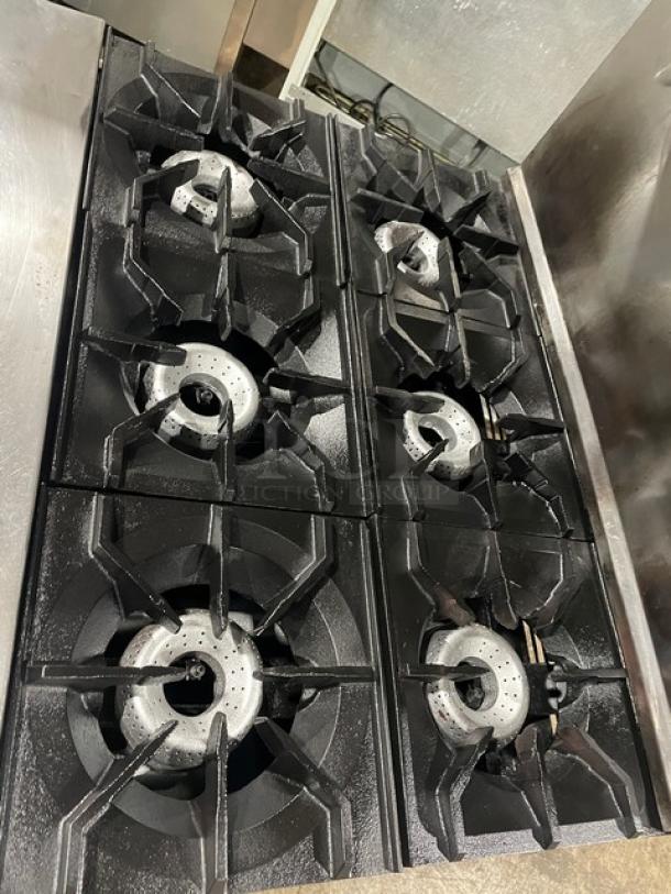 American Range stainless steel 6-burner natural gas range/oven combo, with backsplash, overhead shelf, and wired rack.