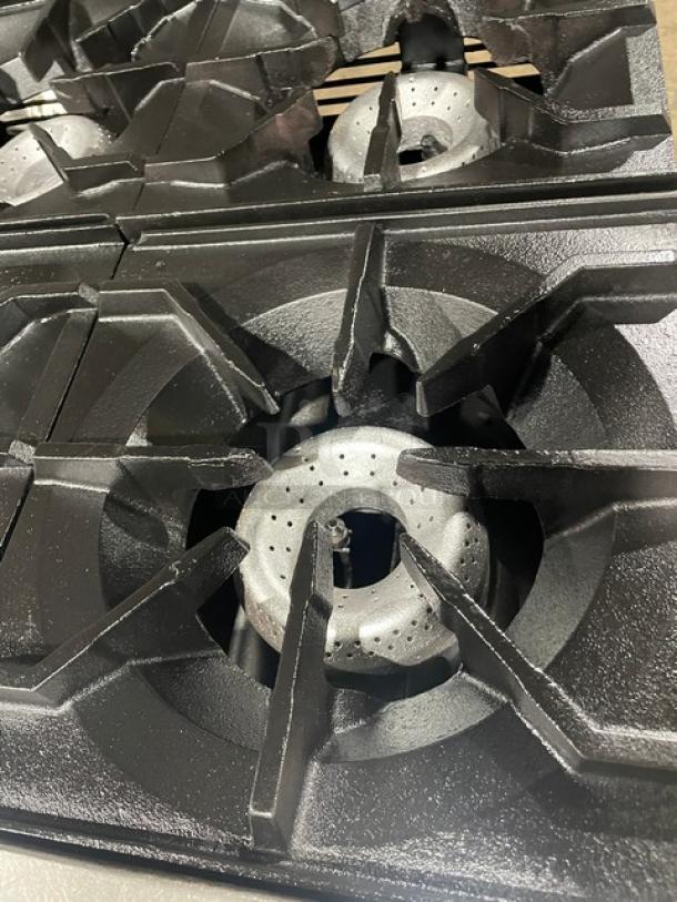 American Range commercial 6-burner natural gas stove with durable cast iron grates. Features include a backsplash, overhead shelf, and wired rack.