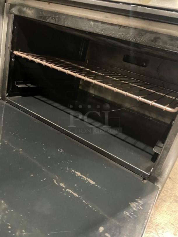 American Range stainless steel 6-burner range/oven combo with wired rack, natural gas, legs, backsplash, and overhead shelf.