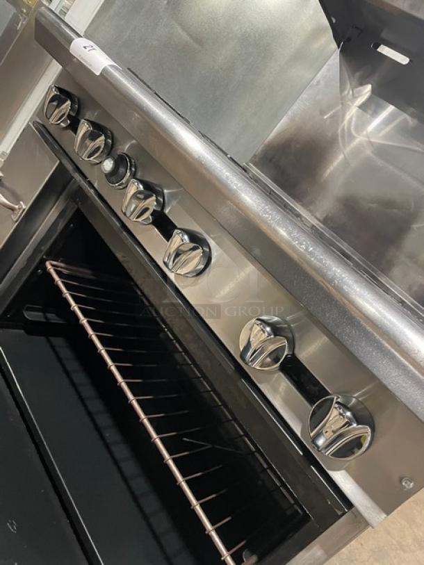 American Range commercial stainless steel 6-burner range/oven combo, natural gas, with backsplash, overhead shelf, and wired rack.