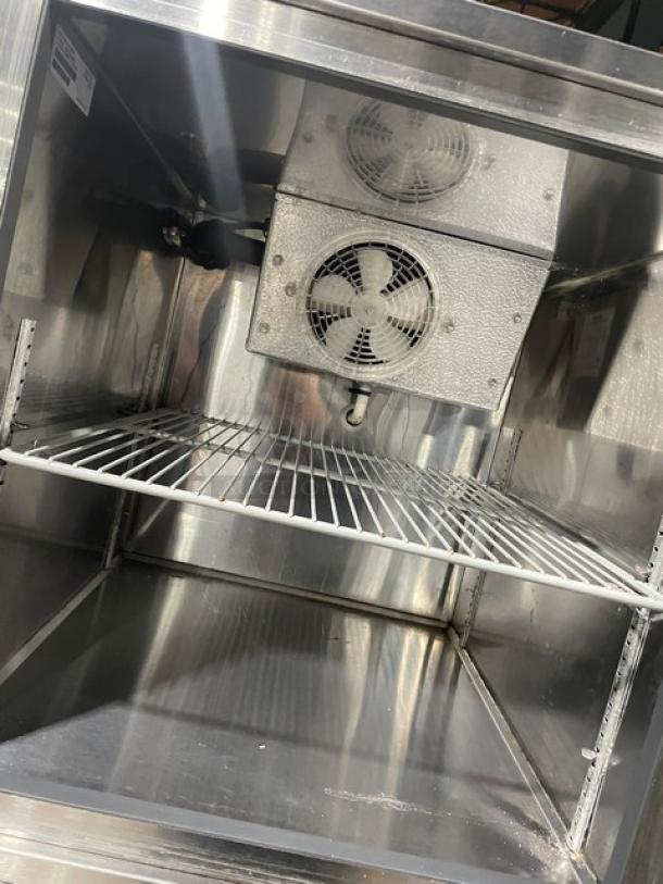 Follett REF5 stainless steel medical-grade refrigerator, featuring a poly-coated wire rack and dual fans, model SN: E14055-27213.