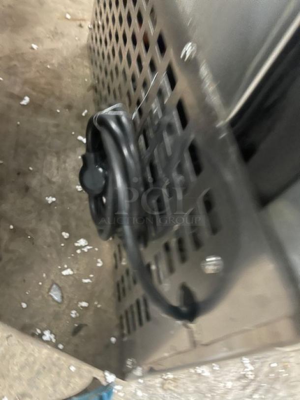 Follett REF5 medical-grade stainless steel undercounter refrigerator. Includes poly-coated wire rack. Minor wear visible.