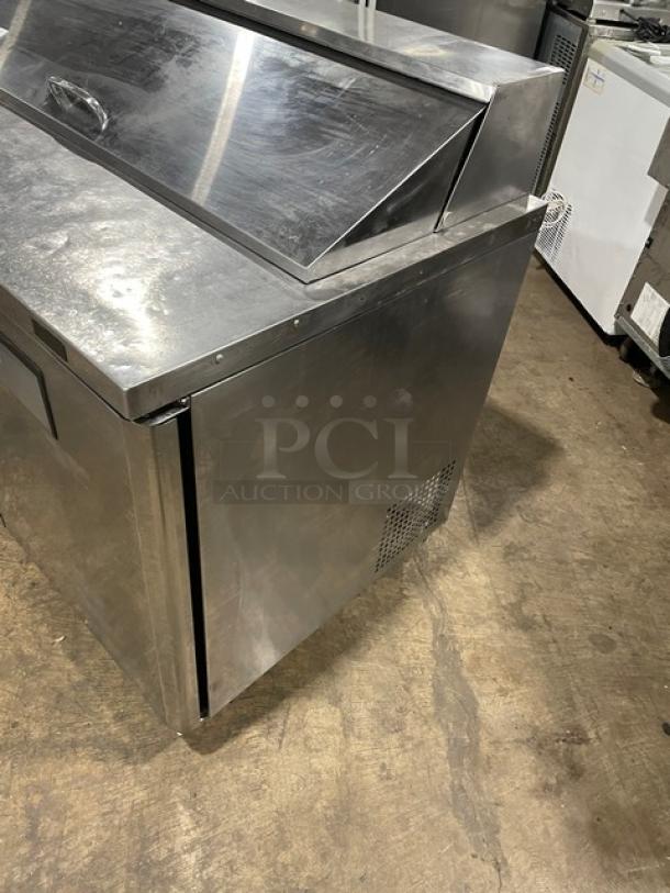 Turbo Air MST-48-N stainless steel 2-door refrigerated prep table with poly-coated rack, on casters, in good condition.