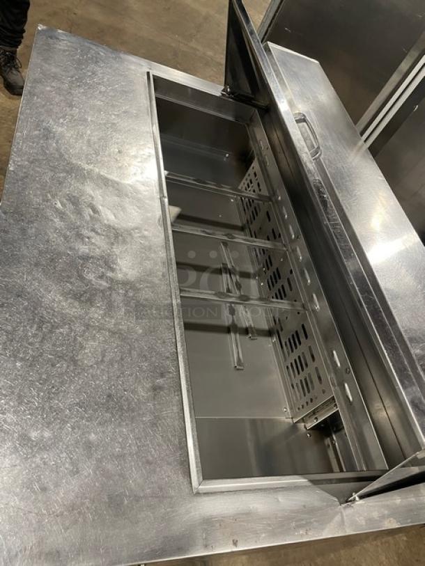 Turbo Air MST-48-N stainless steel refrigerated prep table, 2 doors, poly-coated rack, on casters, in good condition.