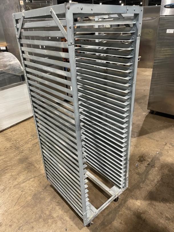 Commercial refrigerator/proofer rack on casters, metal construction, multiple shelves, used condition, ideal for bakery use.