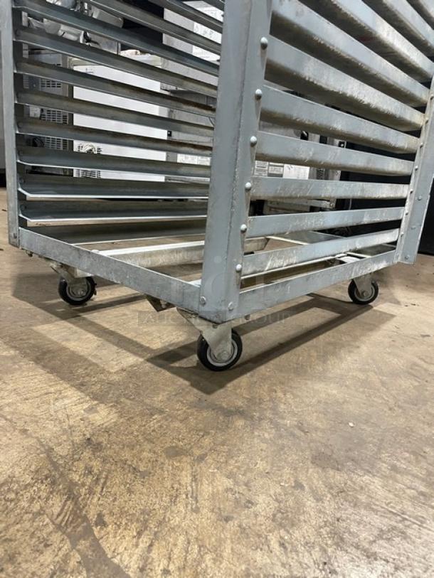 Commercial refrigerator/proofer rack on casters, metal frame, multiple shelves, used condition.