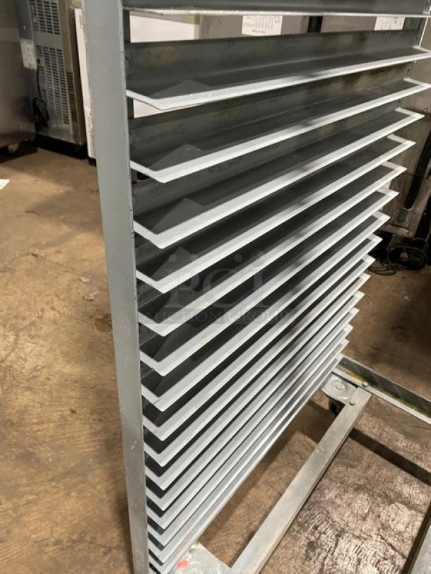 Commercial refrigerator/proofer rack on casters, multiple shelves, metal construction, suitable for bakery or restaurant use.