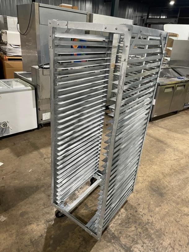 Commercial refrigerator/proofer rack on casters, metal construction, excellent condition, suitable for bakery or restaurant use.
