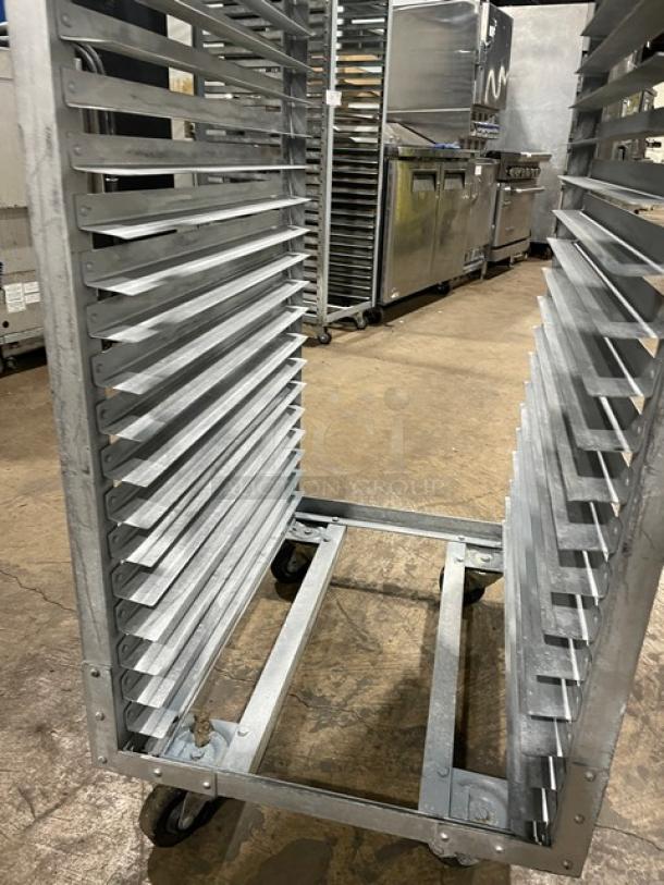 Commercial refrigerator/proofer rack with multiple shelves, metallic finish, on casters for mobility. Good condition.