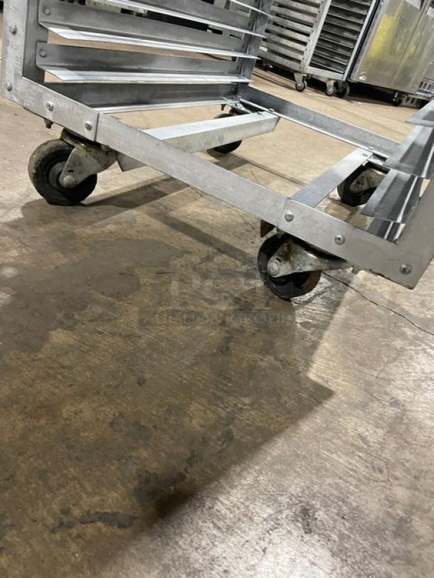 Commercial refrigerator/proofer rack with metal frame on sturdy casters. Used condition. Ideal for bakery or kitchen use.